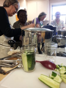 participants in pickling workshop making dill pickles