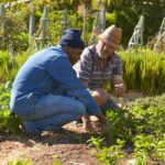 Men Talking by Garden