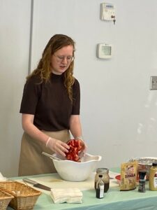 Laurel Davis, NC State Summer Intern, demos the strawberry quinoa salad prep